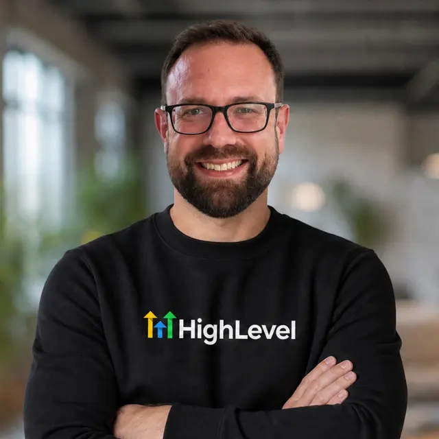 Gareth Richardson, GoHighLevel developer and HighLevel Certified Admin, arms crossed in a HighLevel jumper